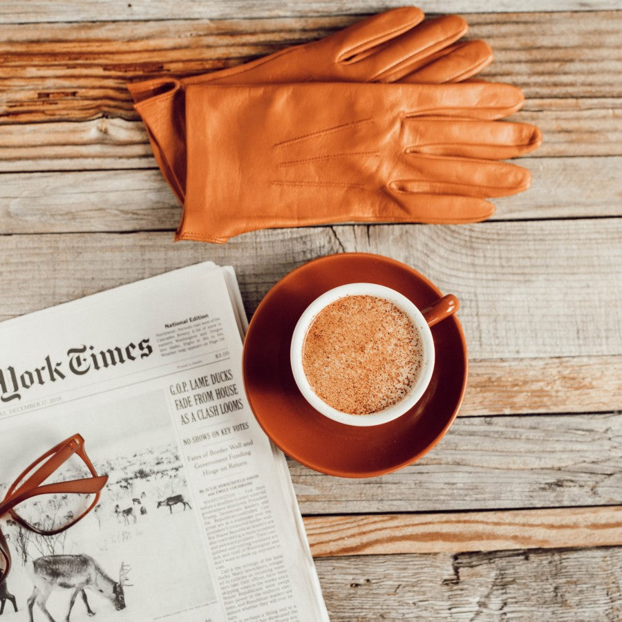 The New York Times Newspaper With A Cup Of Organic Coffee And Leather Gloves