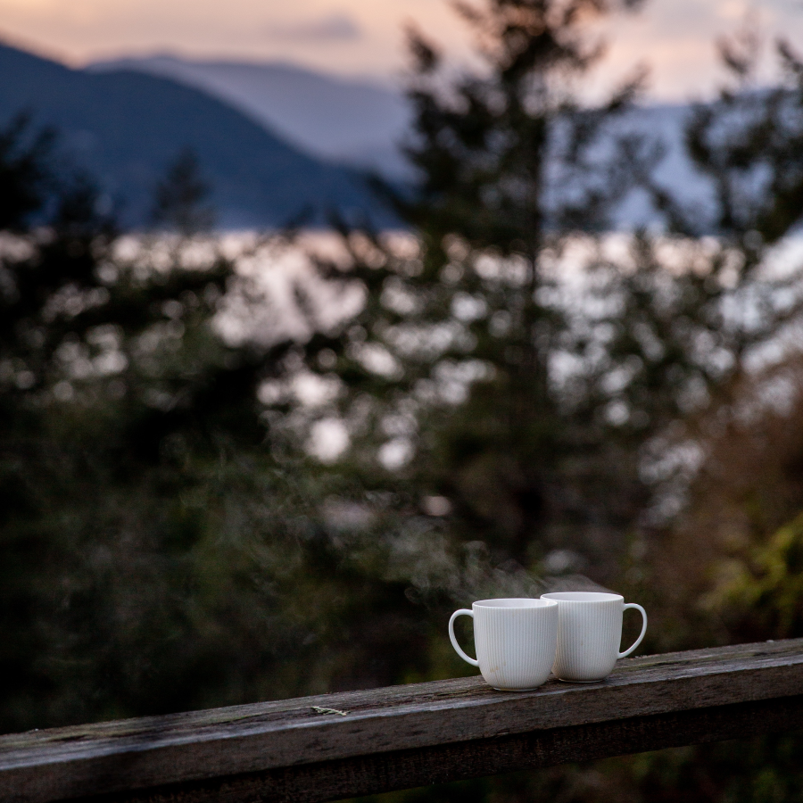 Two White Mugs Full Of Steaming Decaffeinated Coffee Enjoyed On The Deck In The Evening