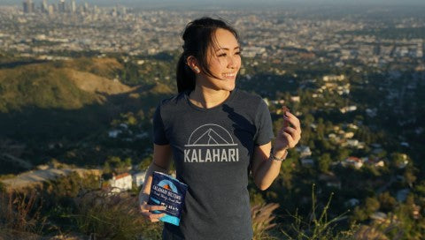 Woman Outdoors Eating Garlic Biltong In Kalahari Shirt