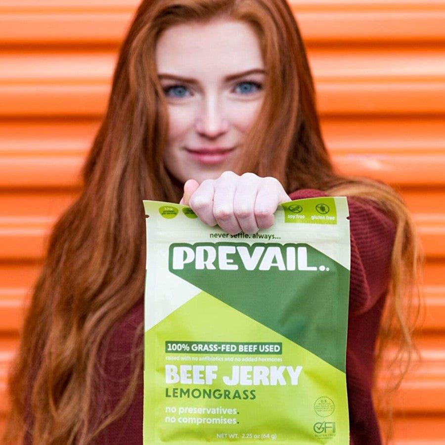 Woman Holding Bag Of Prevail Grass Fed Beef Lemongrass Jerky