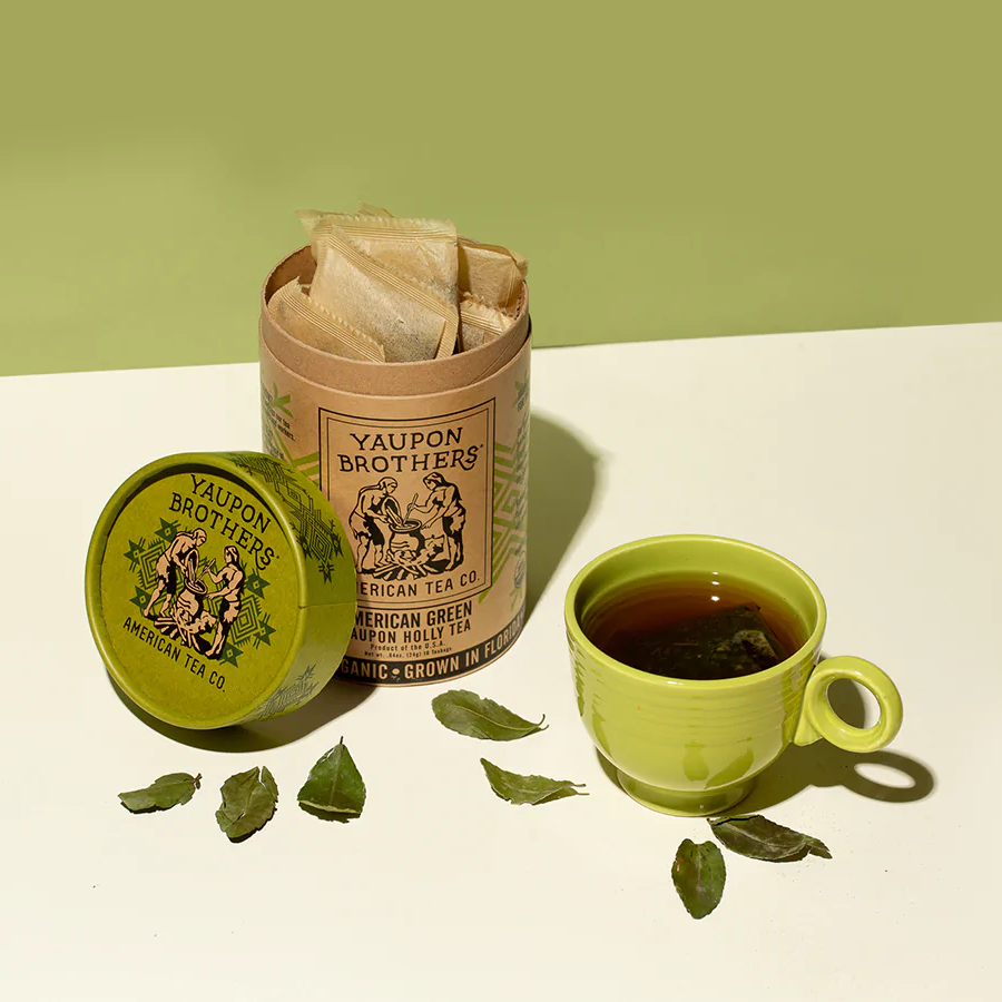 Eco Friendly Canister Of Organic Tea Yaupon Brothers American Green Holly Tea Leaves And Cup Of Tea
