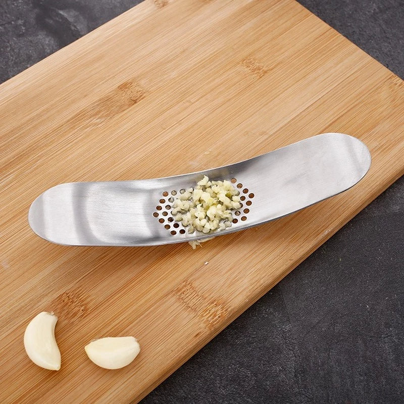 Boat Shape Two Handed Rocker Style Garlic Press Easily Minces Garlic On Bamboo Cutting Board