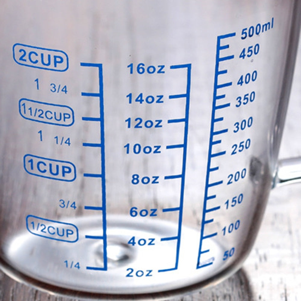 2 Cup Glass Measuring Cup With Blue Writing Showing Cups Ounces And Milliliters